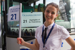 Tour guide Nina Kazarina in front of an Oceania Cruise tour bus in St. Petersburg, Russia 